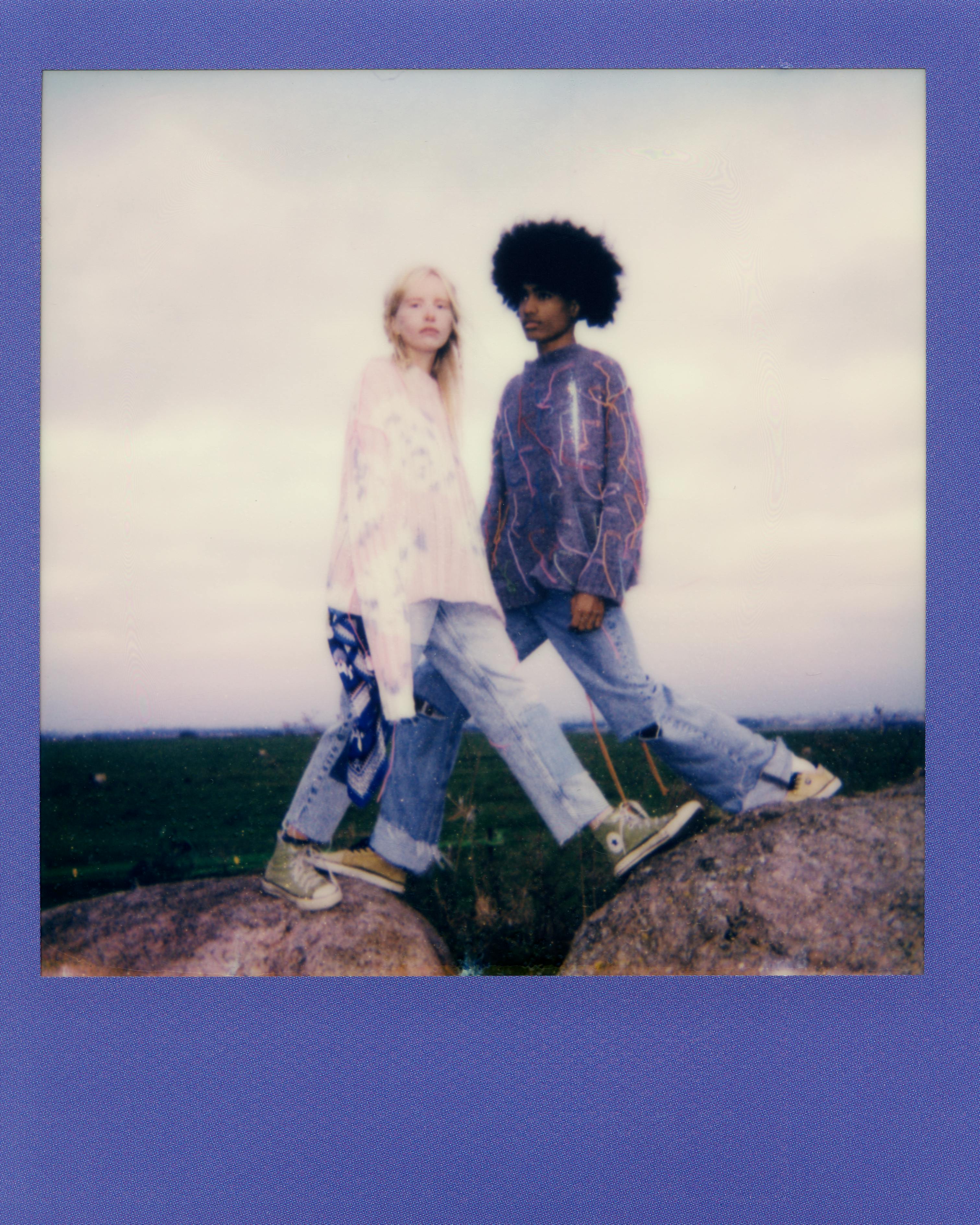 couple standing over gap in rock