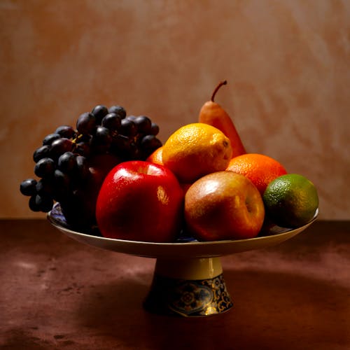 Red Apples and Green Grapes on Brown Wooden Bowl