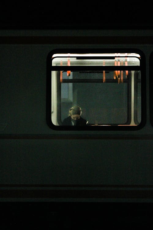 A Person Wearing Face Mask Riding in the Train