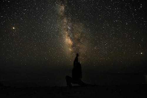 Free Silhouette of a Person under the Starry Night Sky Stock Photo