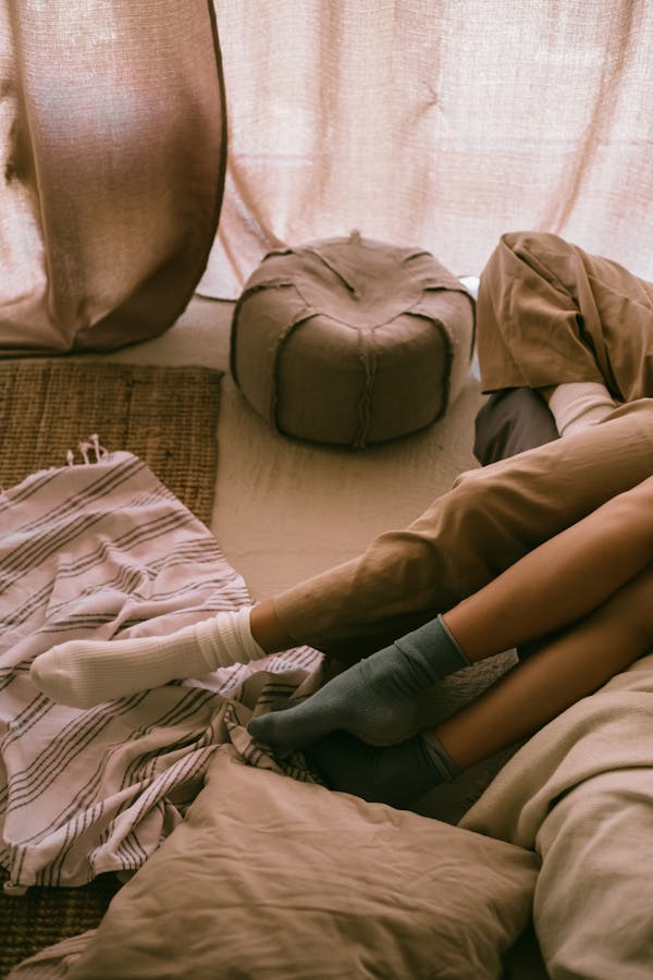 Womens Legs on Bed and Pillows