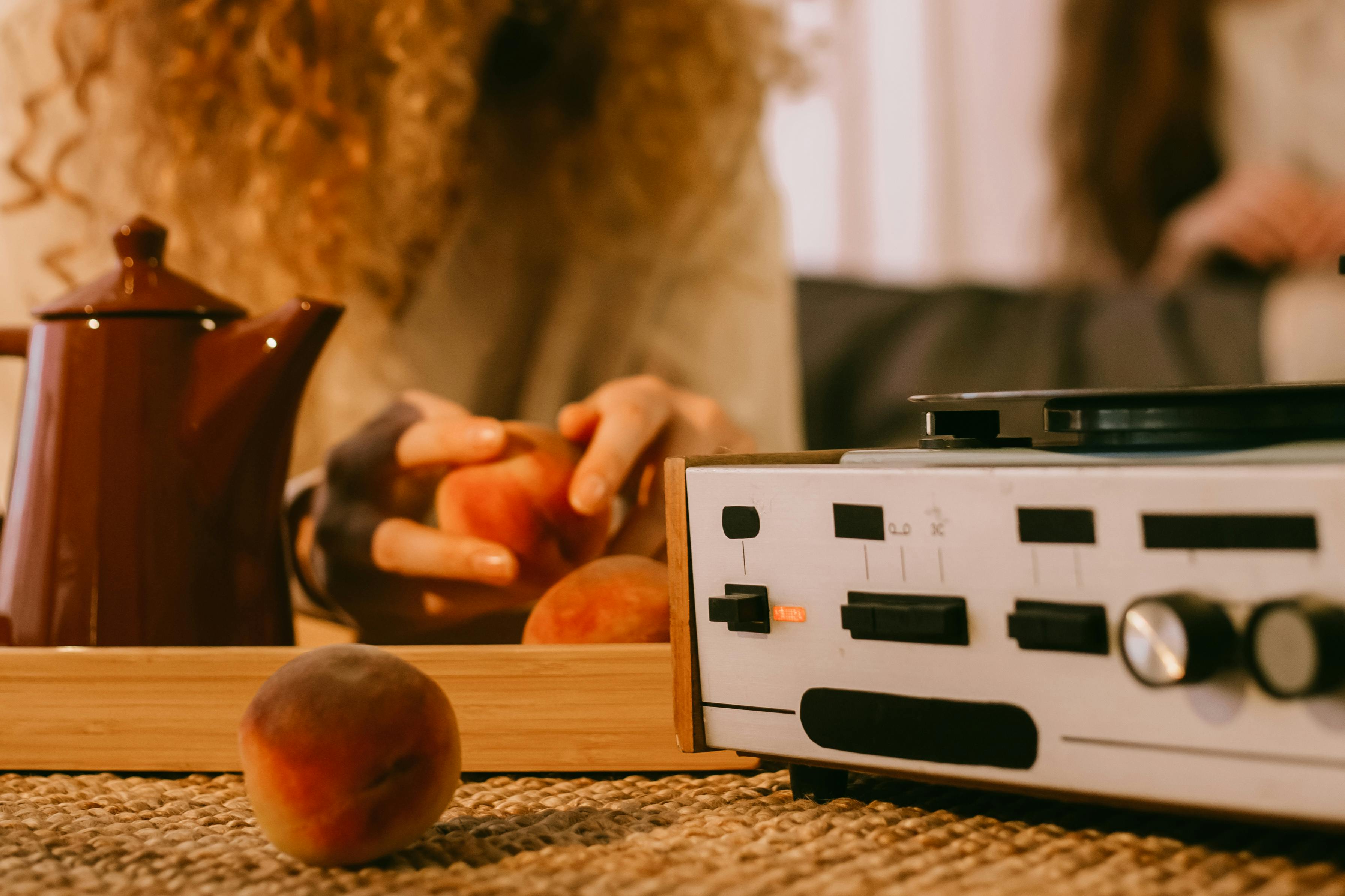 women eating fruits and listening to vinyl record player