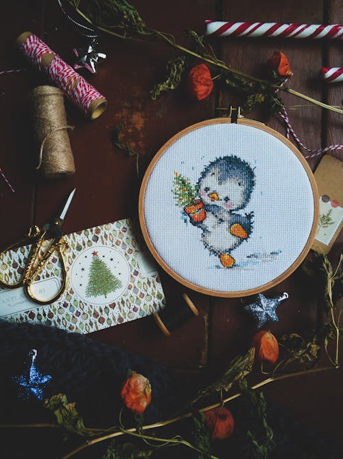 A Cute Cross Stitch Project on a Wooden Surface