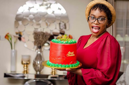 Free Woman in Red Long Sleeve Shirt Holding Red Cake Stock Photo