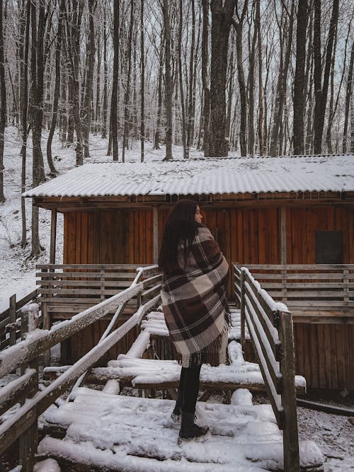 Woman Covered with Brown Scarf Standing on a Wooden Bridge while Looking Afar