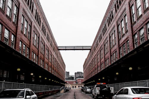 Red Painted Building With Cars Under It