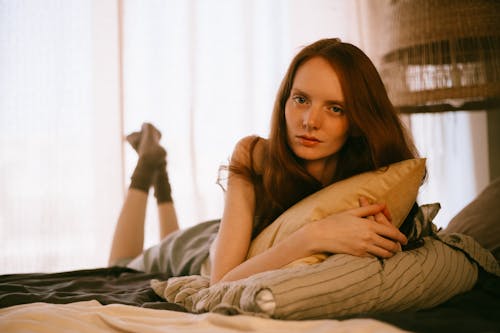 Redhead Lying on Front on Bed