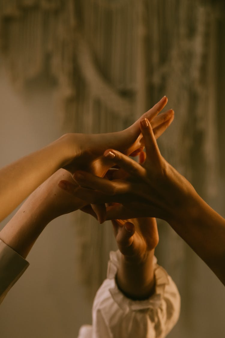 Close-up Of Girls Holding Outstretched Hands