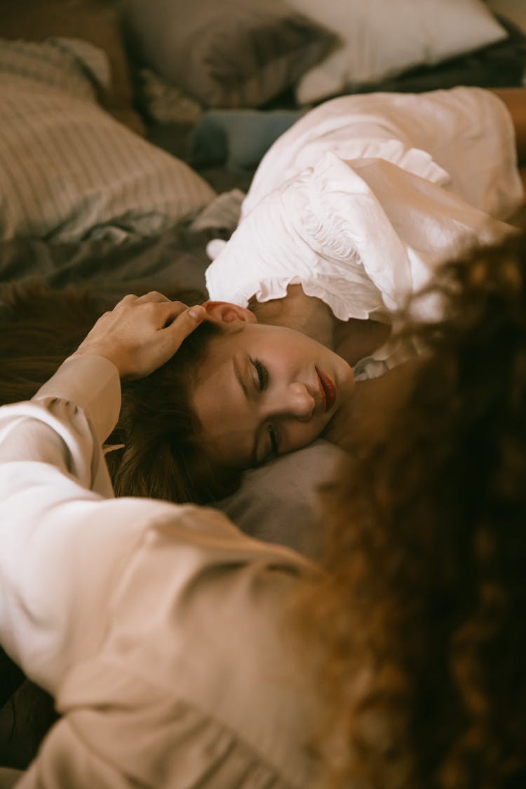 Woman Stroking Her Friends Hair