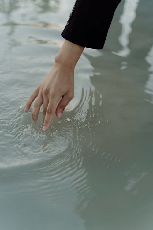Woman Hand Touching Water Surface