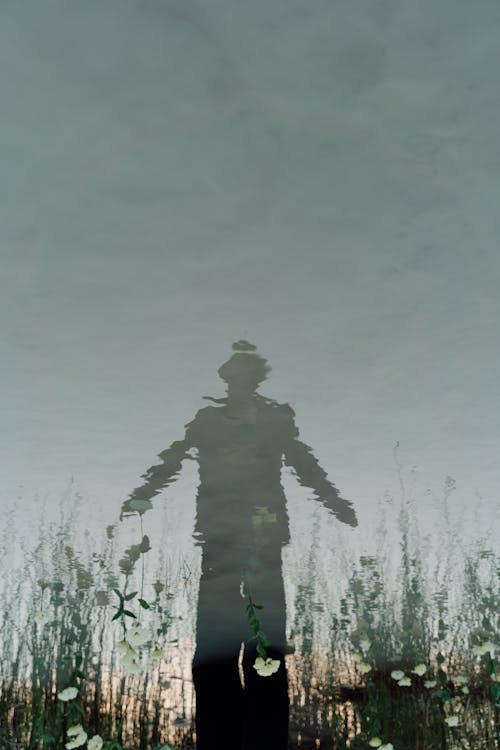 Person Silhouette Reflected in Pond