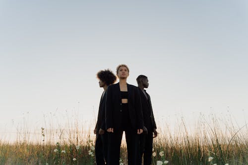 Woman in Black Suit Standing beside Man in Black Suit