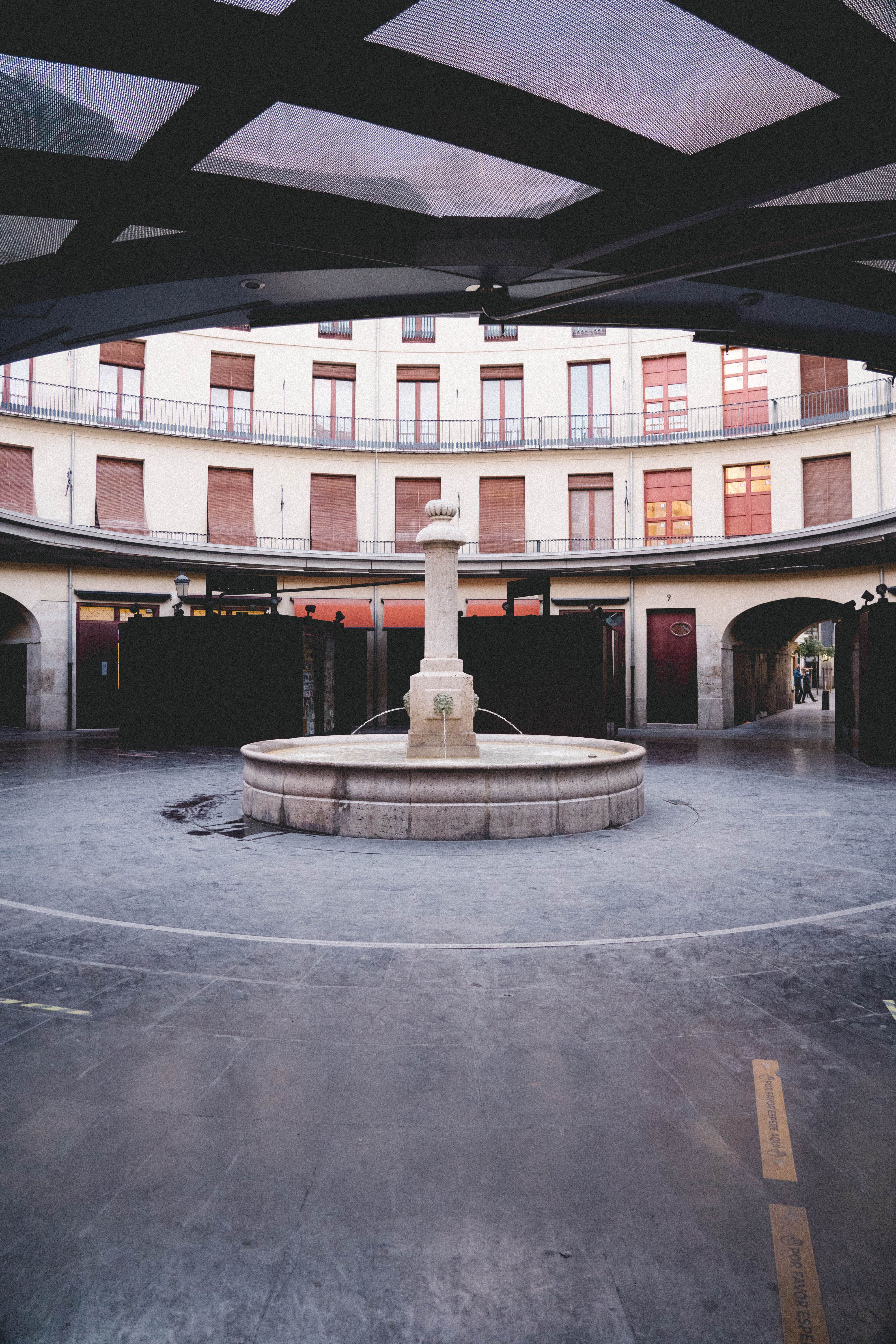 Captivating view of the historical fountain at Plaza Redonda, Valencia, showcasing unique circular architecture.