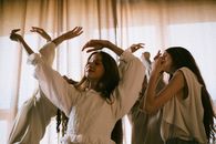 Teenage Girls Dancing with Their Hands Up