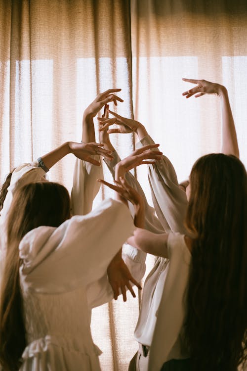 Free Teenage Girls Dancing with Their Hands Up Stock Photo