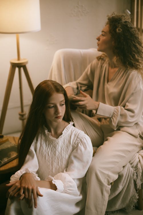 Woman Braiding Teenage Girl Hair