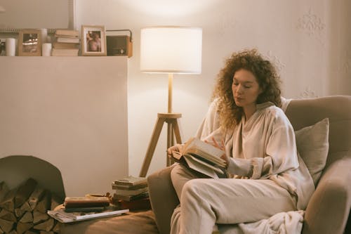 Woman Holding Book and Daydreaming