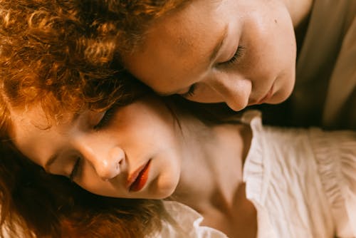 Women Embracing with Eyes Closed