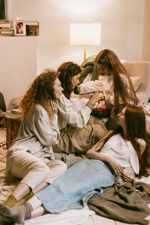 Free Redhead Women Talking on the Phone during Sleepover Stock Photo