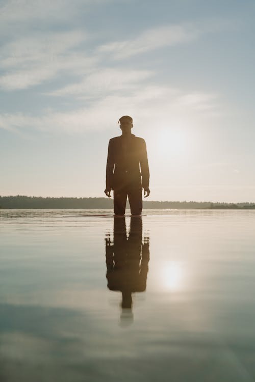 Free Man in Black Blazer Standing on Shallow Water Stock Photo