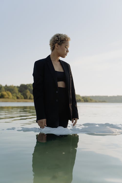 Woman in Black Blazer Standing in the Water
