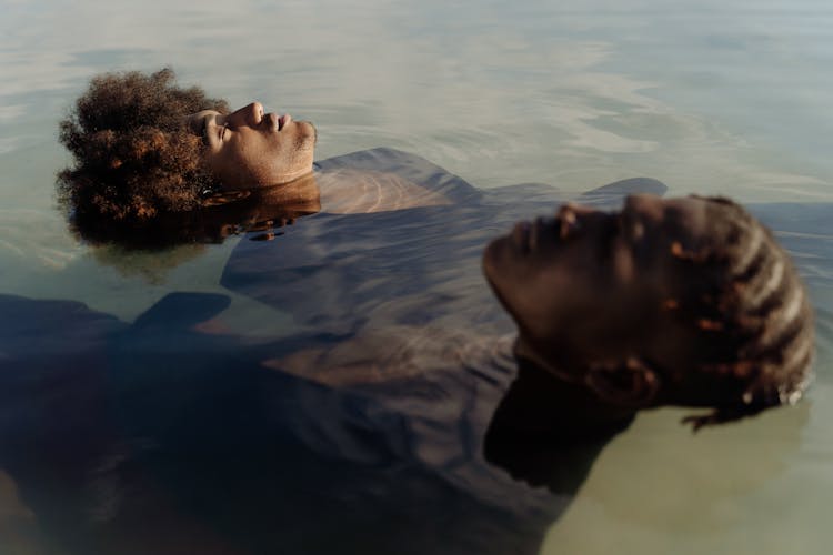 Men Floating In Lake