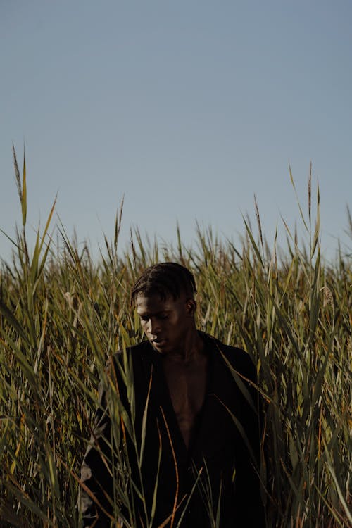 A Man Posing in a Tall Grass Field