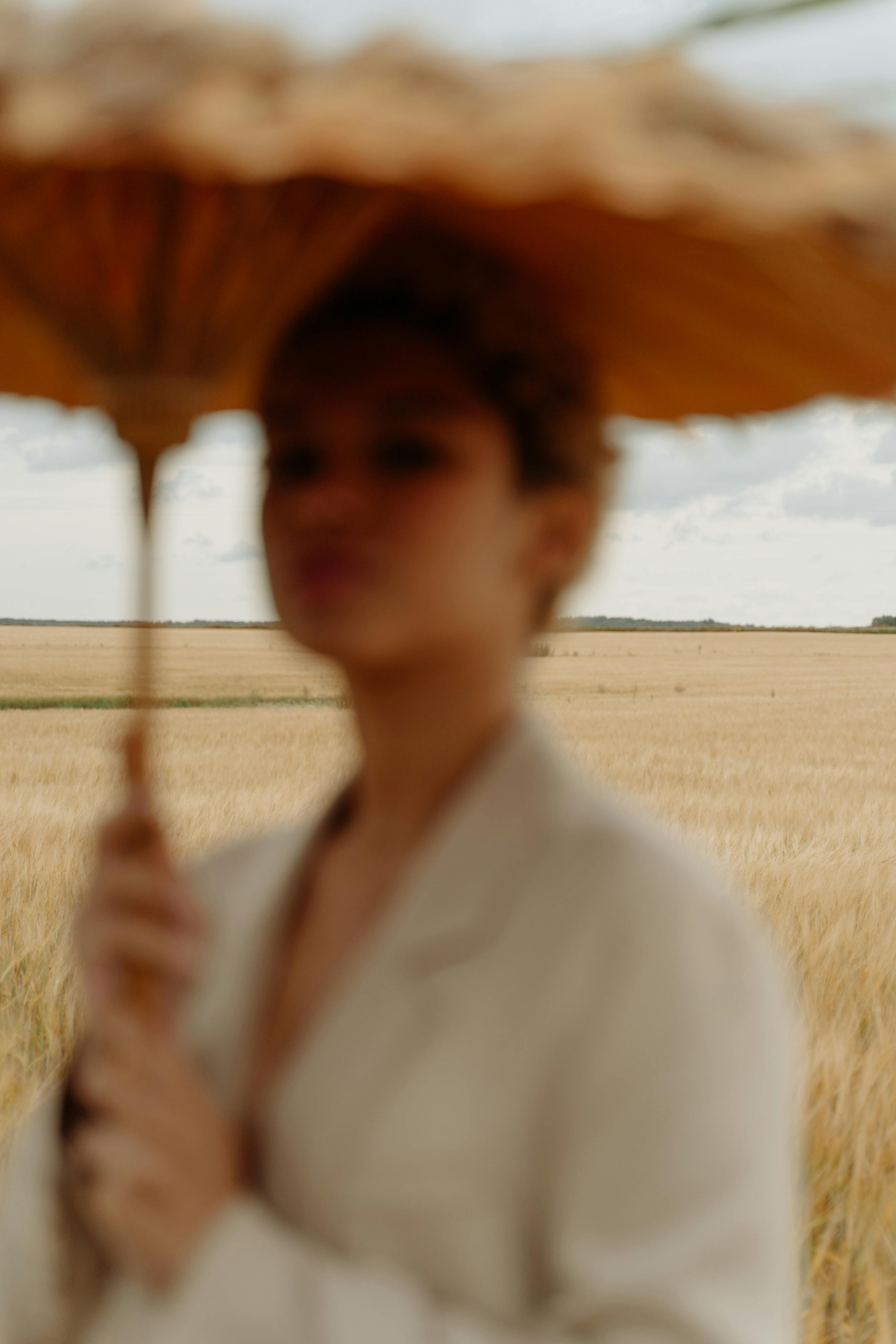 blur photo of woman holding umbrella