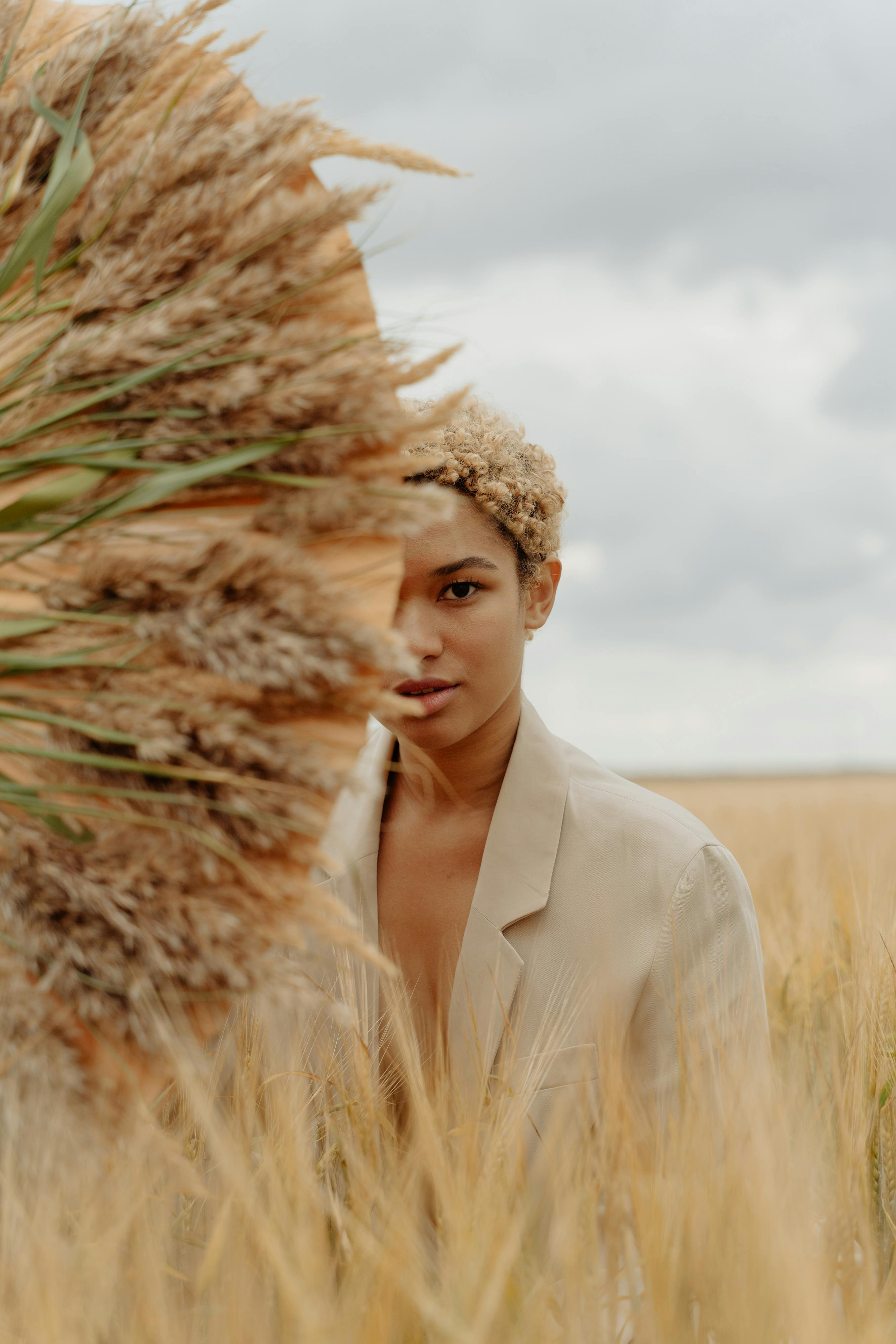 woman with wheat umbrella on field