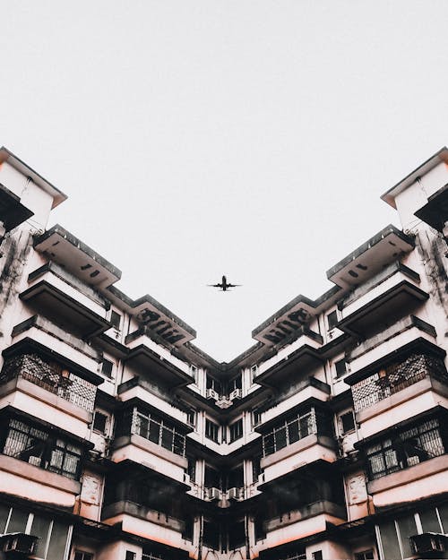 Free Airplane over Building Stock Photo