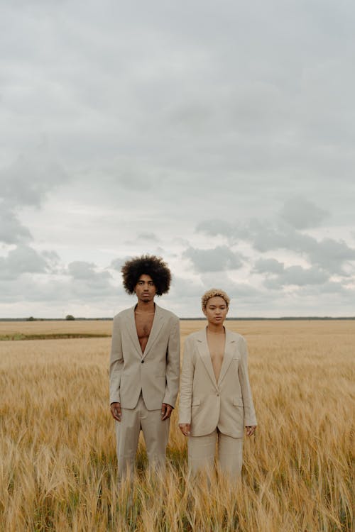 Man and Woman Standing on Wheat Field