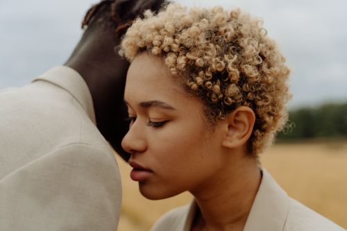 Free Close-up of a couple embracing in a serene rural landscape, evoking a sense of intimacy and tranquility. Stock Photo