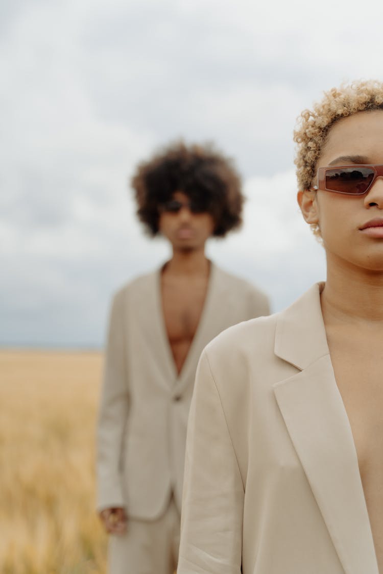 Man And Woman Wearing Jackets And Standing On Field