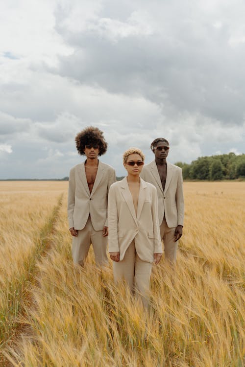 Woman and Men Posing on Field 