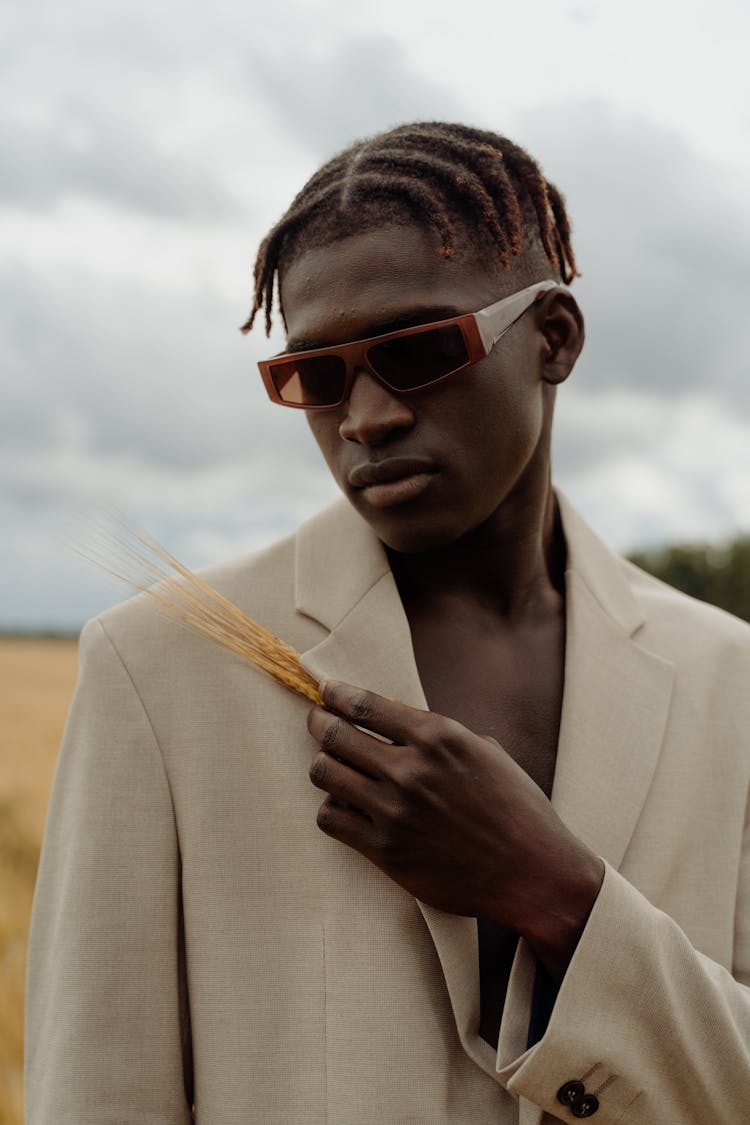 Close-Up Shot Of A Man In Beige Suit Wearing Sunglasses