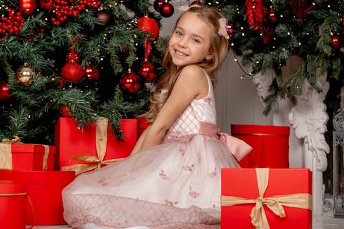 Free Girl in White Sleeveless Dress Standing Beside Christmas Tree Stock Photo