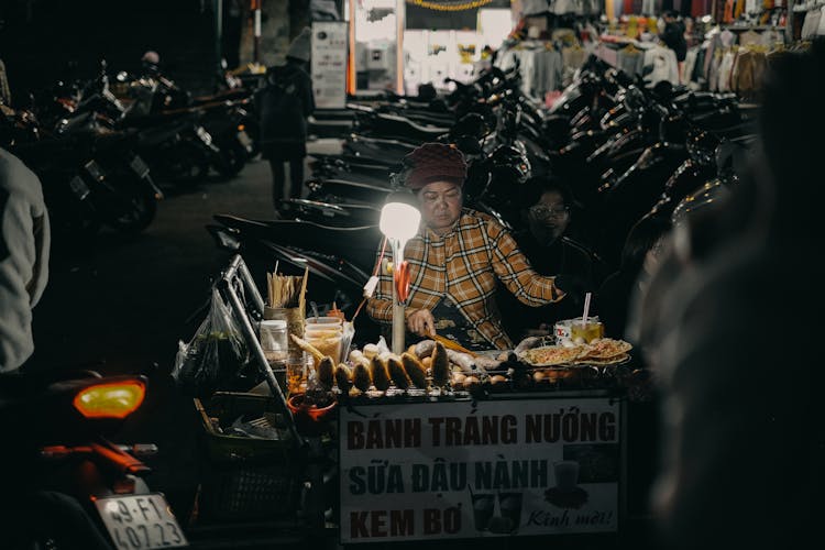 Woman And Man Selling Food On City Street