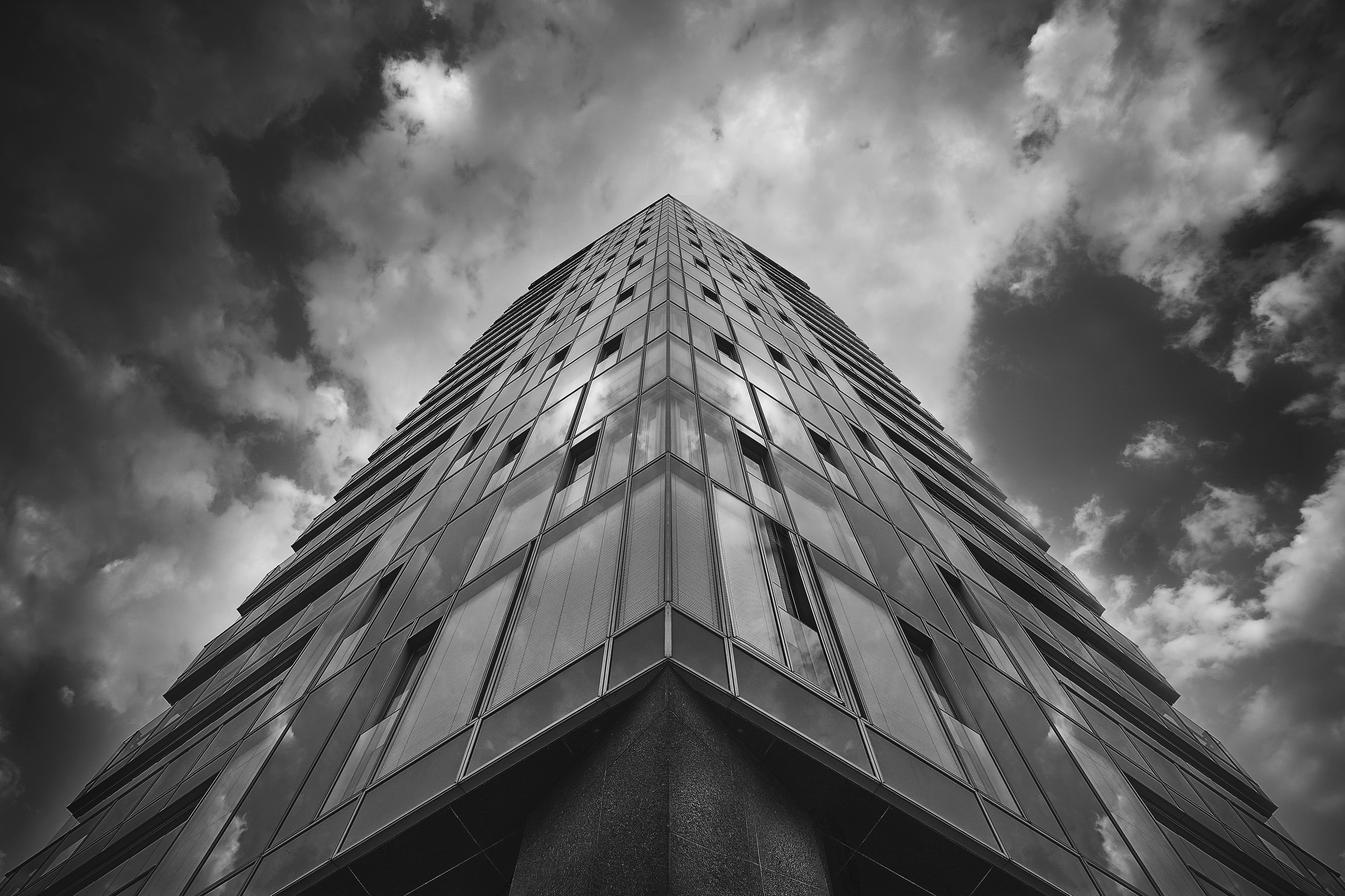 Grayscale Photo of a High Rise Building under the Cloudy Sky · Free ...