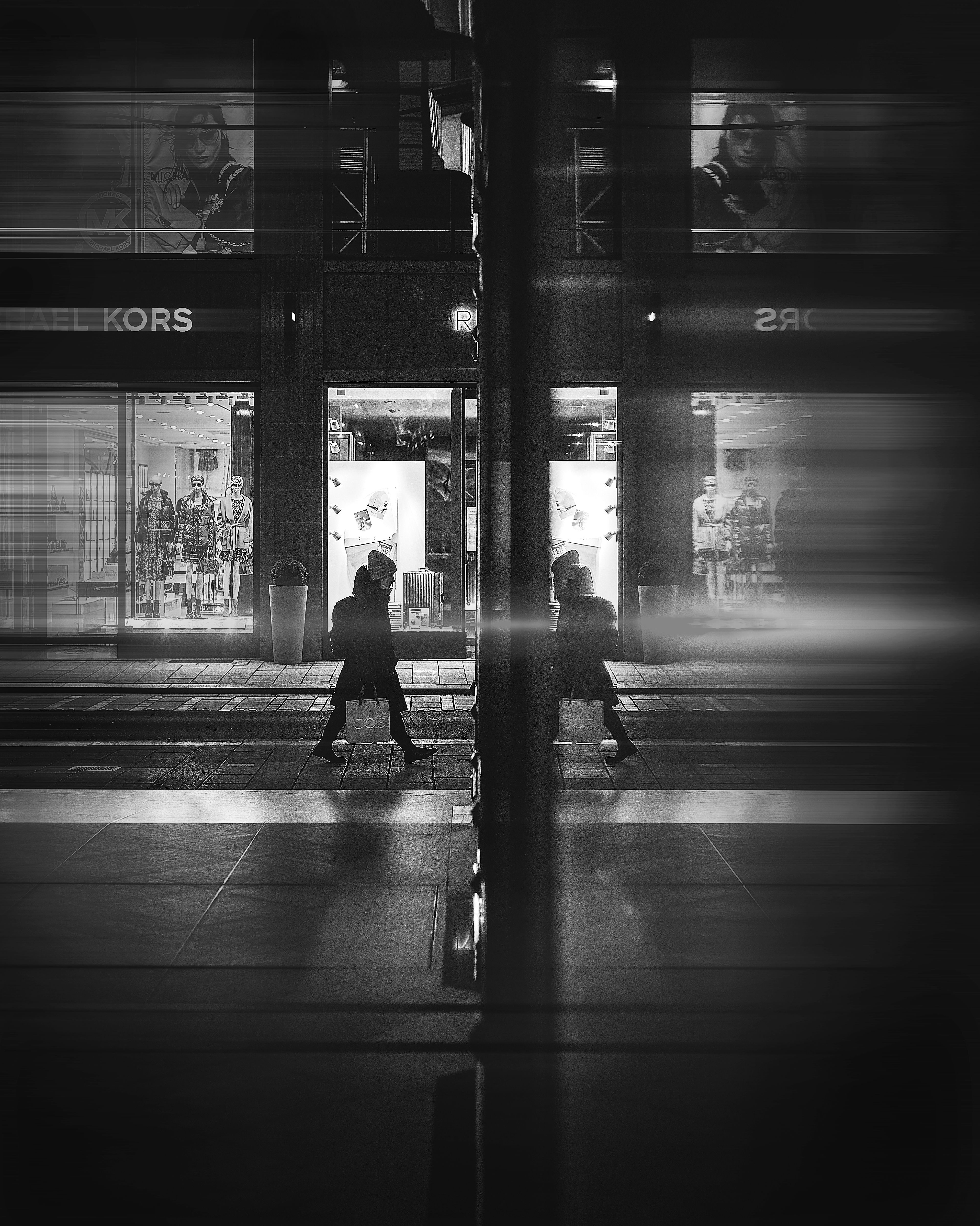 Grayscale Photo of a Person Walking on the Street · Free Stock Photo