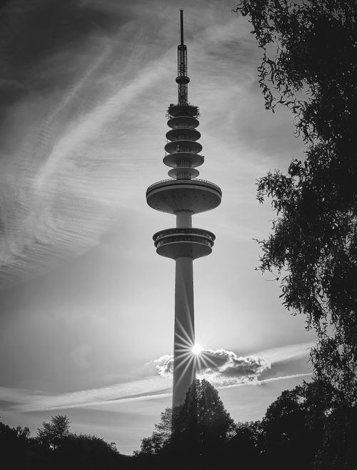 Free Striking black and white photo of Heinrich Hertz Tower in Hamburg with dramatic sky and tree silhouettes. Stock Photo