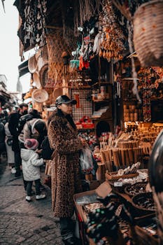 Atmospheric street market with diverse shoppers exploring colorful stalls filled with unique products.