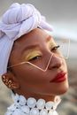 Headshot of Woman Wearing Headscarf and Strong Makeup 