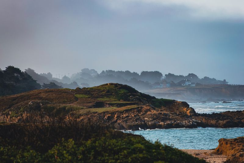Misty headland above a grey sea at dawn — photo by Edwardo Calles from Pexels