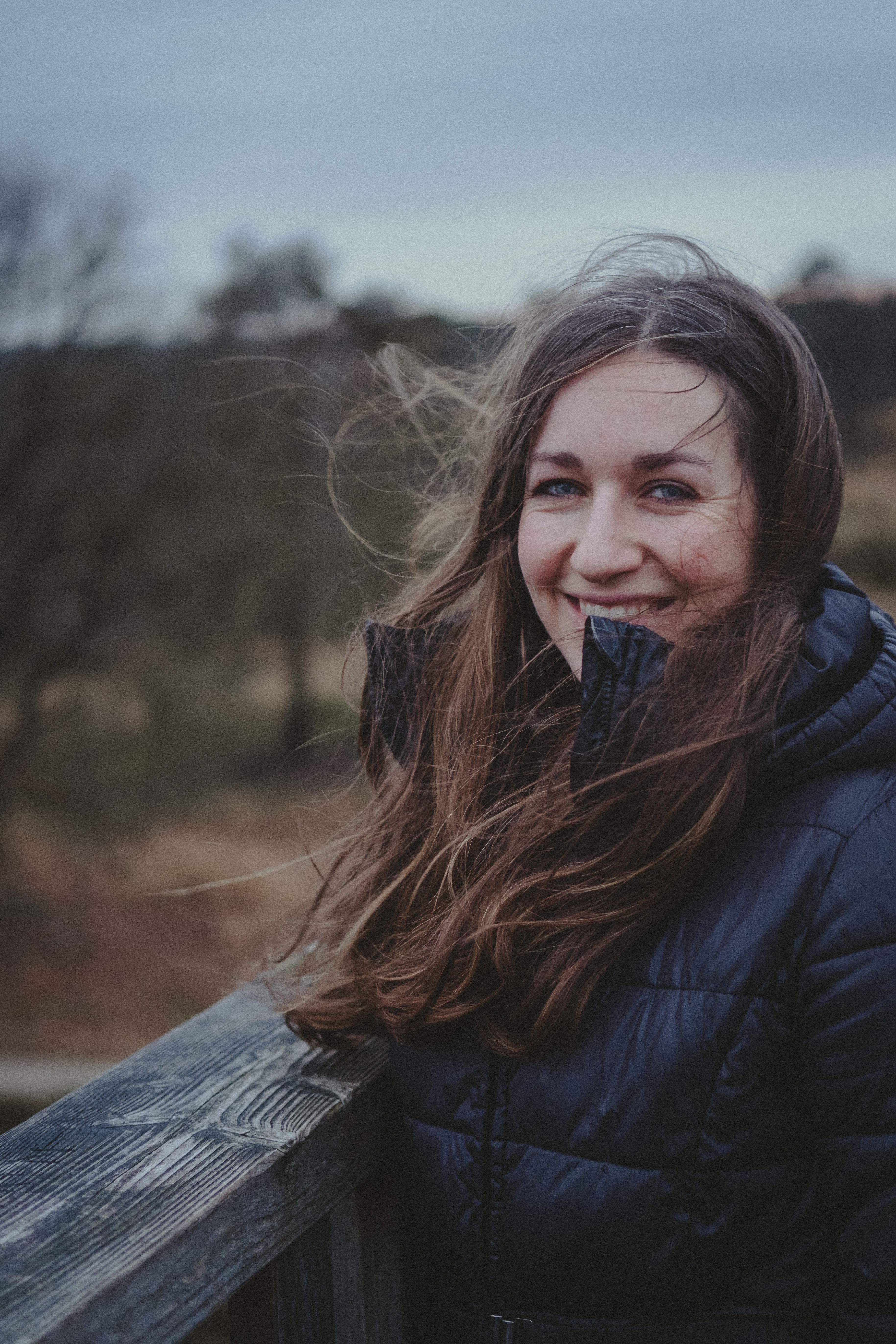 Woman in Black Jacket Standing near Brown Trees · Free Stock Photo