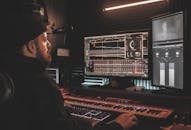 Man in Black Jacket Playing Audio Mixer