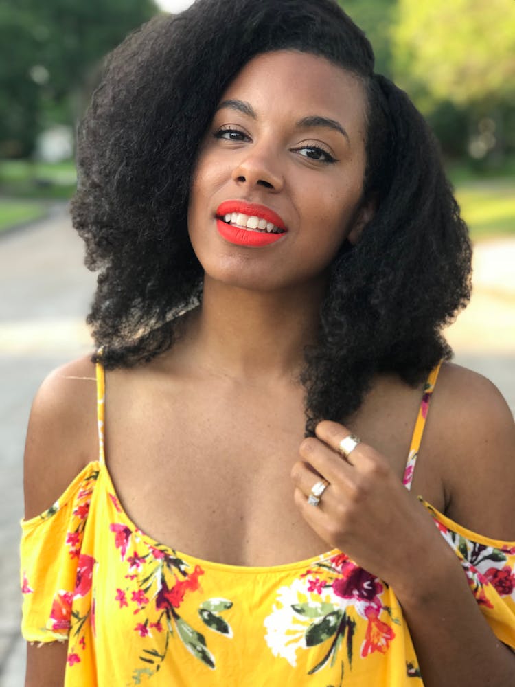 Black Haired Woman In Floral Cold-shoulder Top Smiling