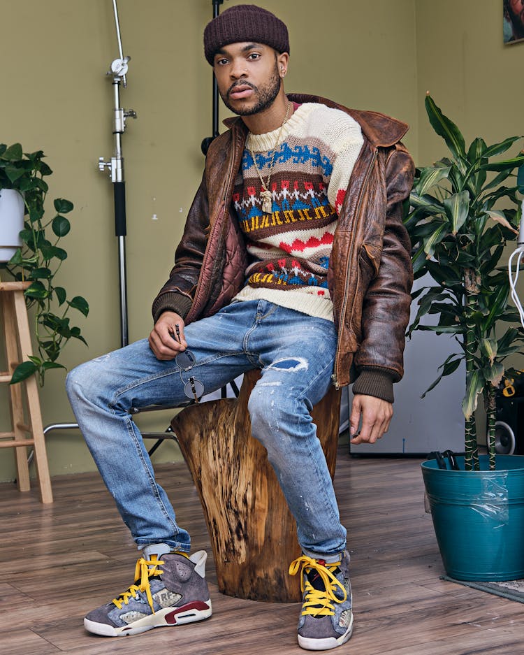 Man Sitting On Tree Trunk In Room