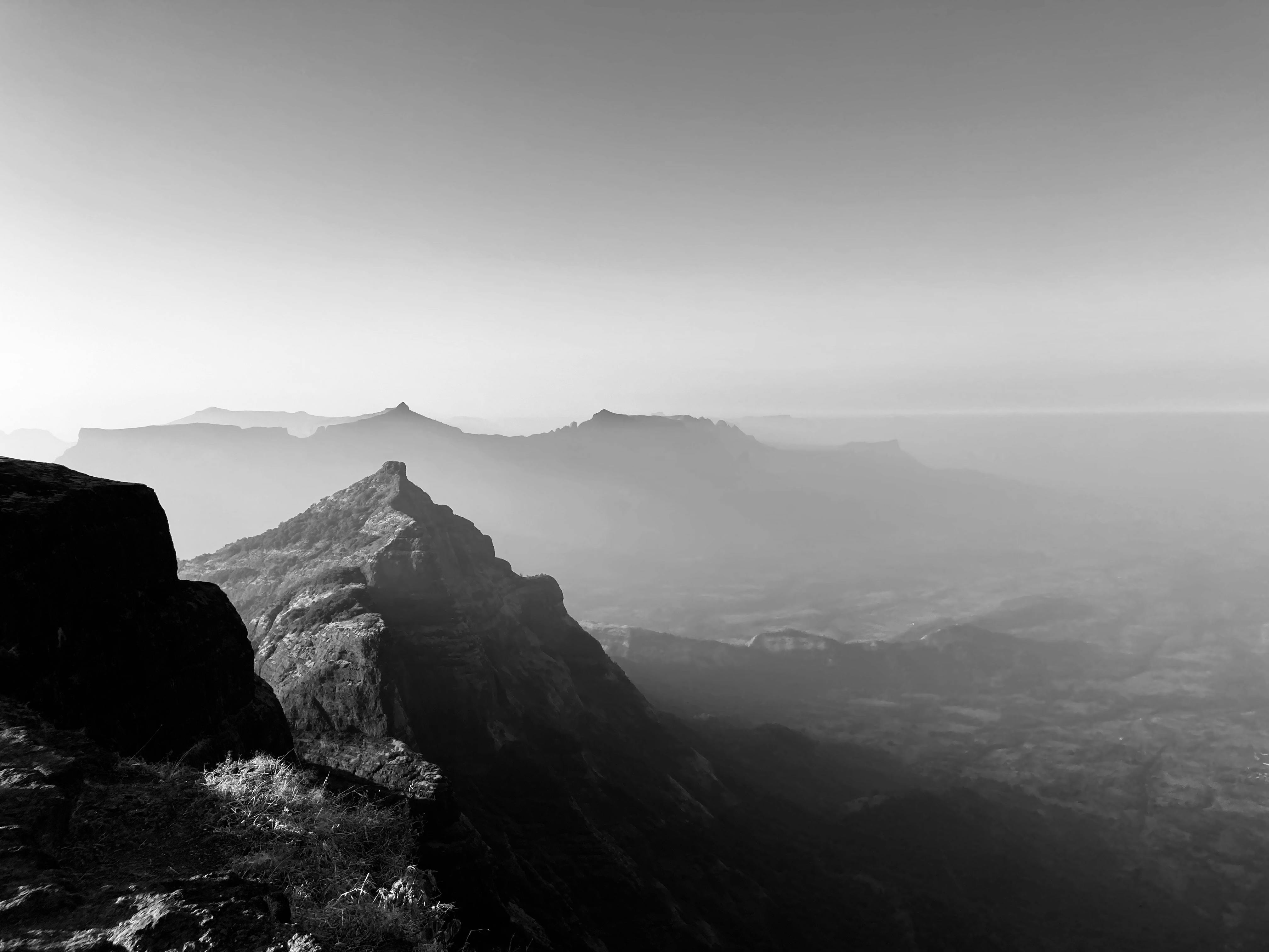 A Grayscale Photo of a Mountains Under the Clear Sky · Free Stock Photo