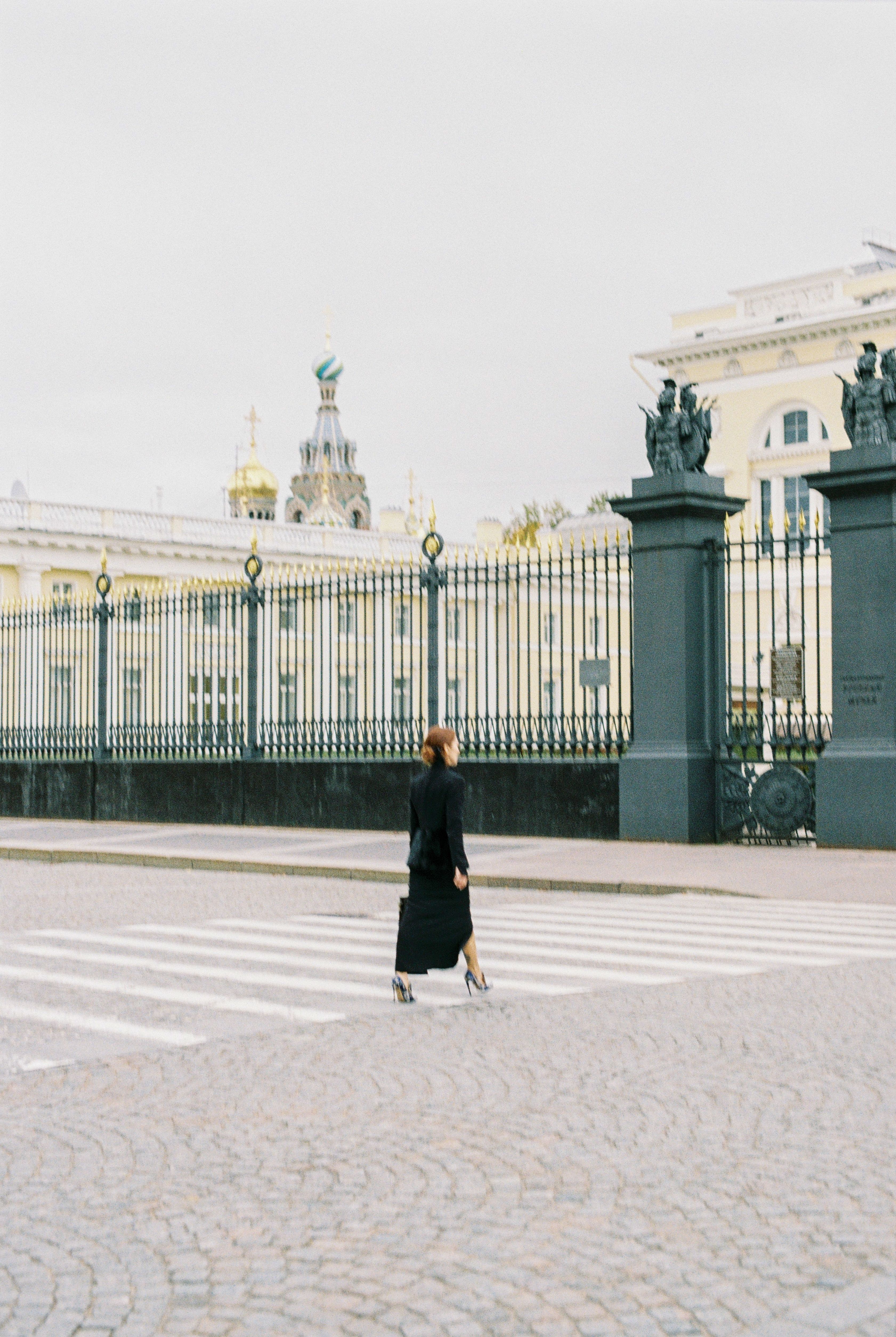 A Woman in Black Dress Walking on the Street · Free Stock Photo