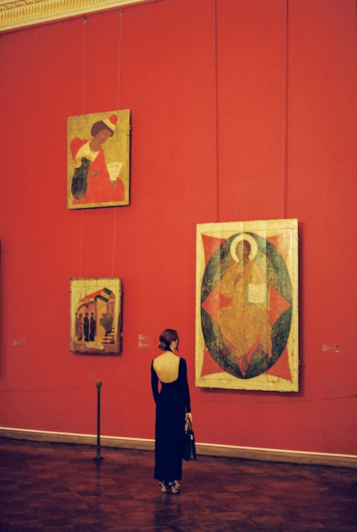 Woman in Black Dress Standing Near Painting
